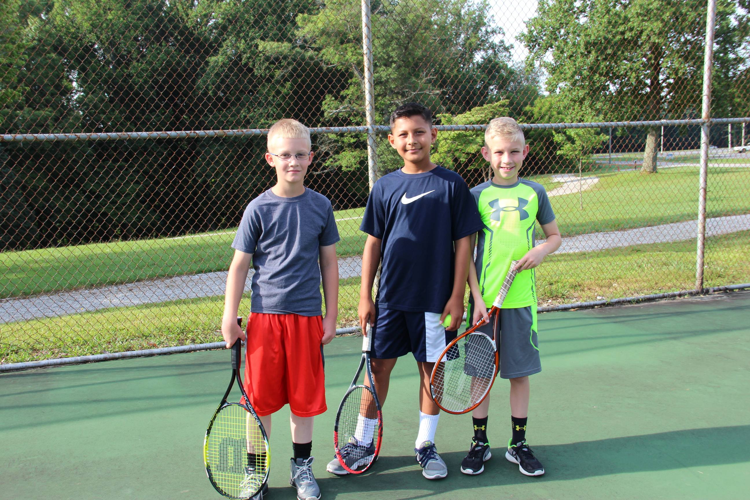 group of boys on tennis field