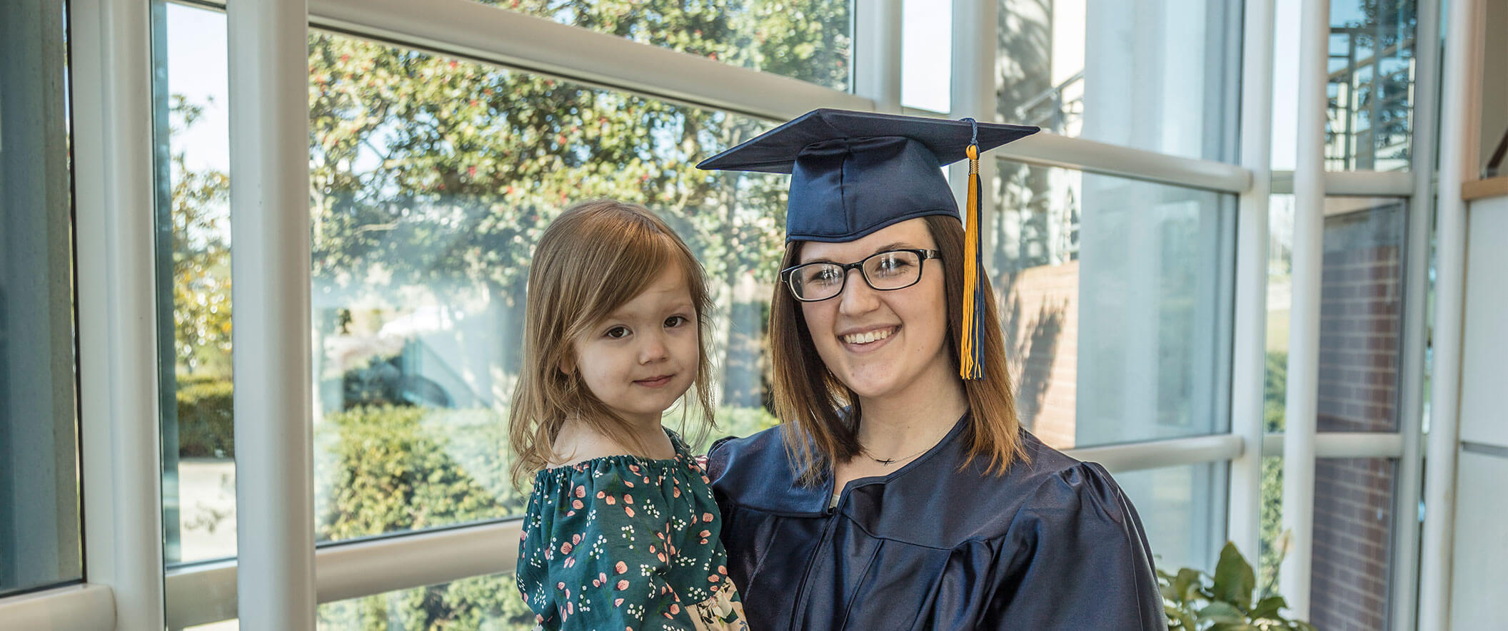woman graduate with daughter