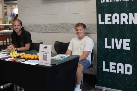 two men from the CCM sitting at a table
