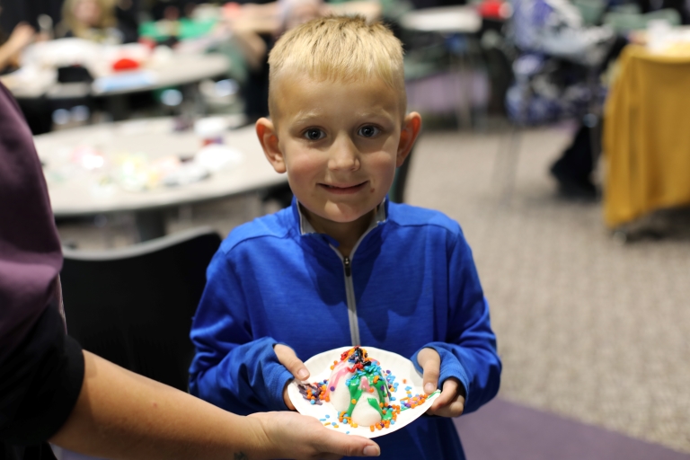 little boy with a sugar skull that he decorated at the SCC International Festival