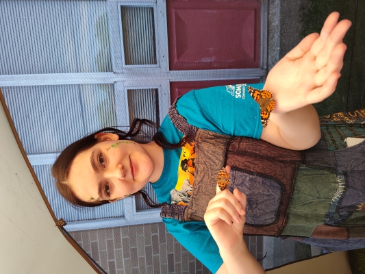 student holding 2 butterflies