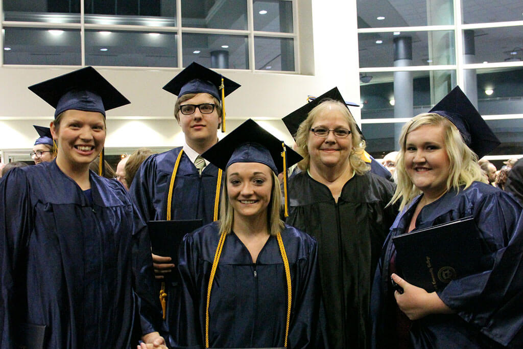 five graduates on graduation day