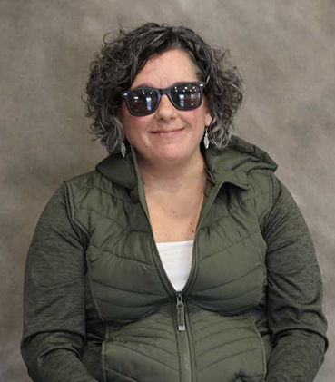 Amanda Cox wearing sunglasses and a puffer jacket