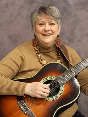 Jennifer Campbell playing a guitar