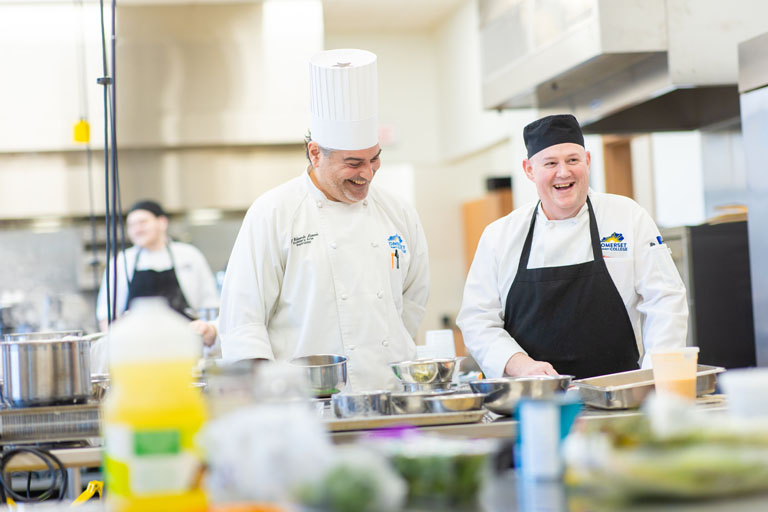 chefs laughing in kitchen