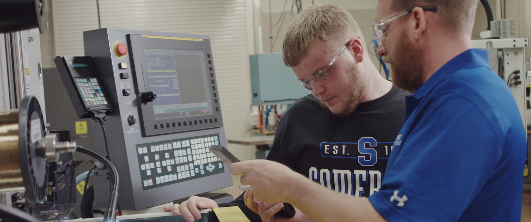 two guys working on machine