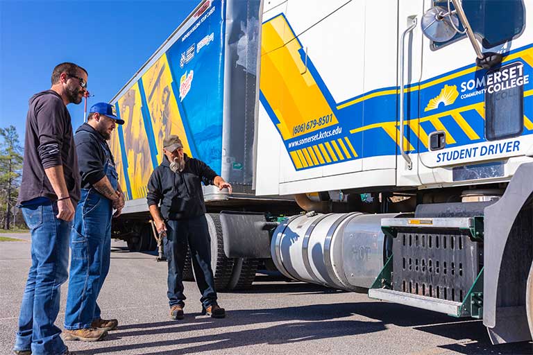 student with an instructor next to a cdl truck