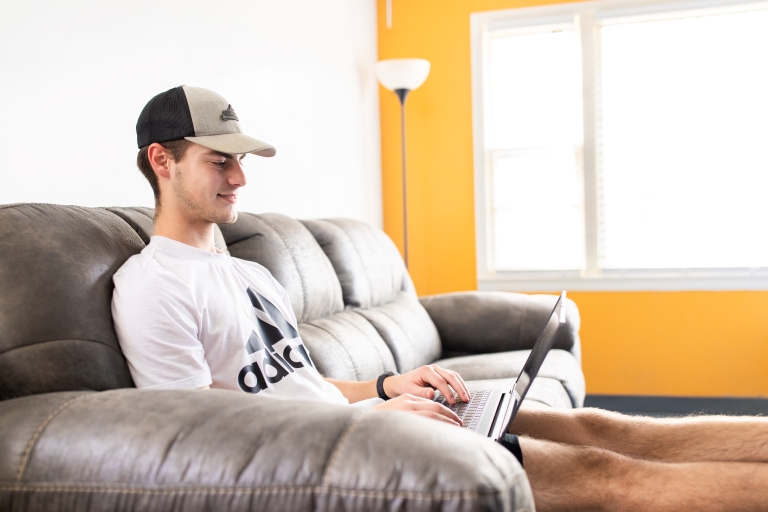 student on a laptop in a living room