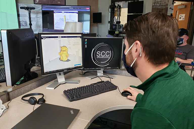 male student working on computer designing 3d models