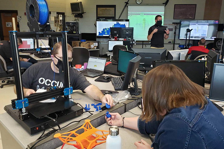 Educators examine the first test prints from the 3D printers they built during Mobile AMP's workshop that concludes the otherwise virtual professional event.