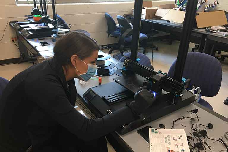 female student using 3d printer