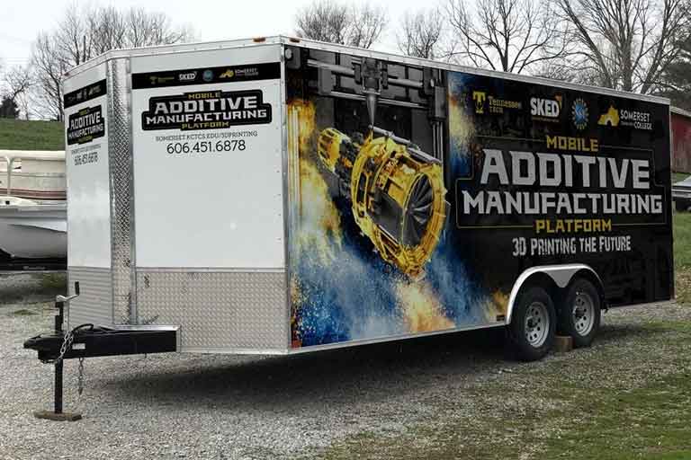 travel trailer with mobile additive manufacturing logo on the side and fronts