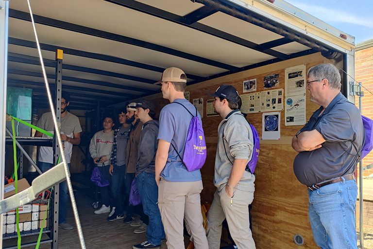 students standing in Mobile AMP trailer