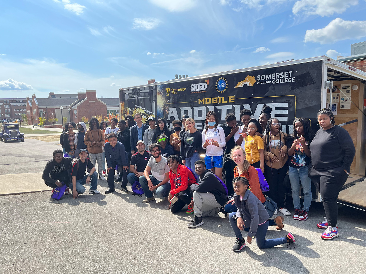 group of students at TTU's Manufacturing Day standing in front of the Mobile AMP trailer