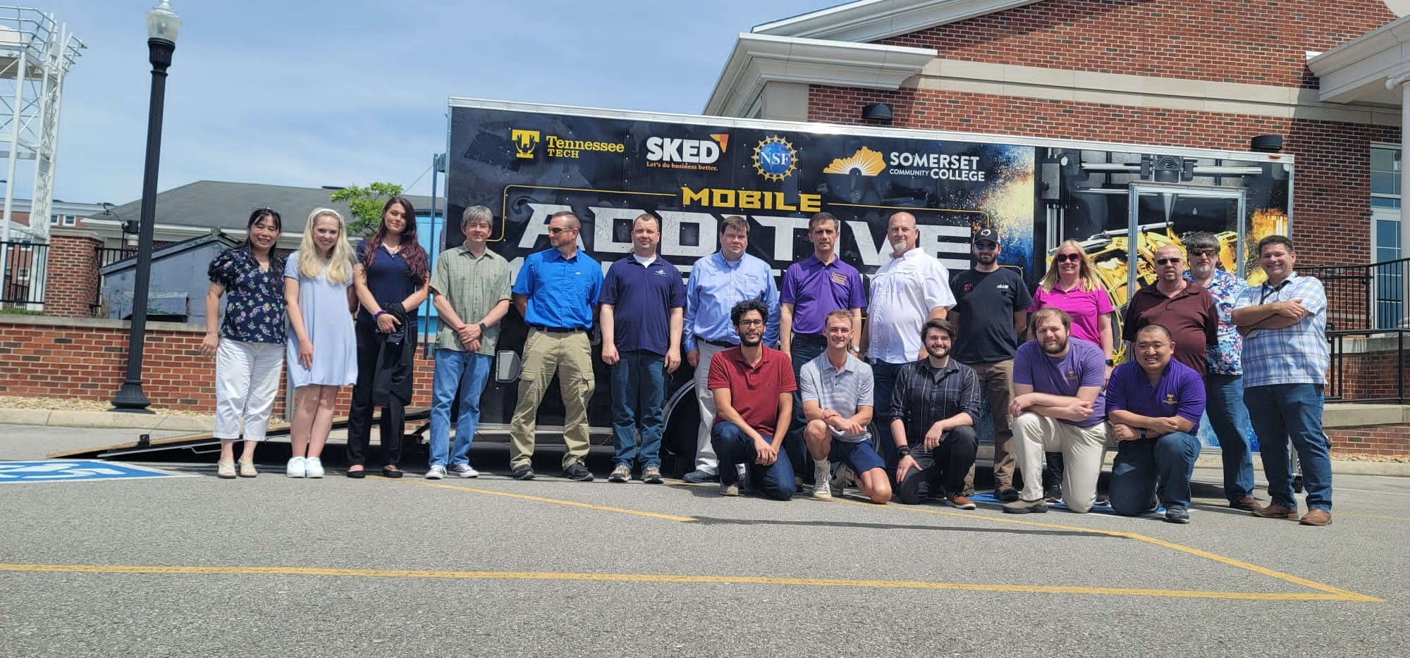 TTU summer 2022 workshop attendees posing with the Mobile AMP trailer