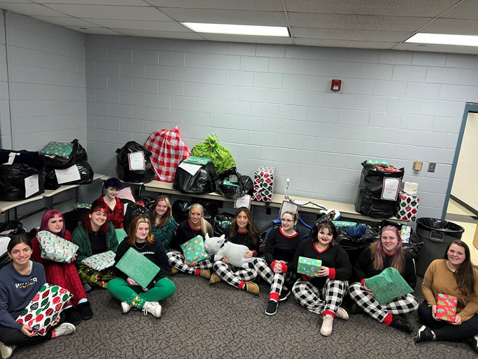 Laurel costmetology club students with wrapped gifts