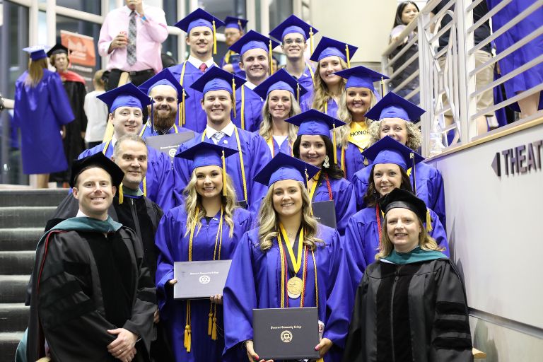 PTA graduates posing for a photo with professors at Commencement ceremony at the center for rural development