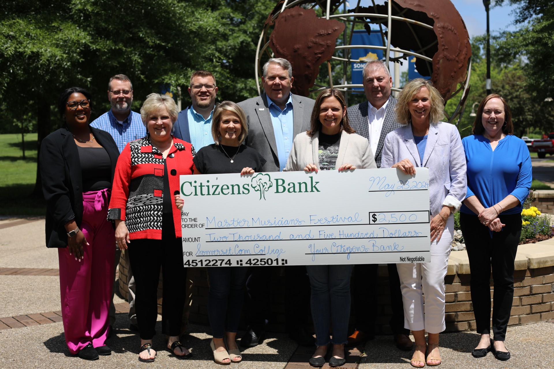 Citizens Bank and SCC staff with a check from Citizens Bank (people named within article)