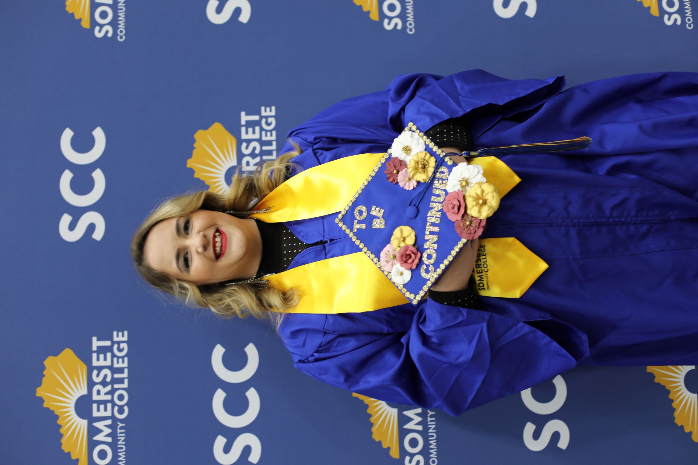 Kaitlyn Crabtree holding her graduation cap that says "To be continued"