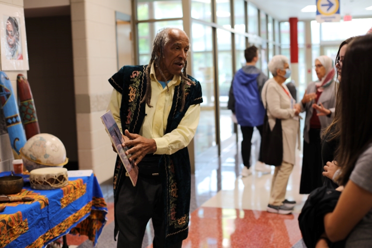 man in cultural attire presenting at the festival