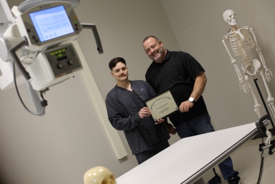 Jacob Davidson and program coordinator Randall Hammock holding the Student of the Month certificate