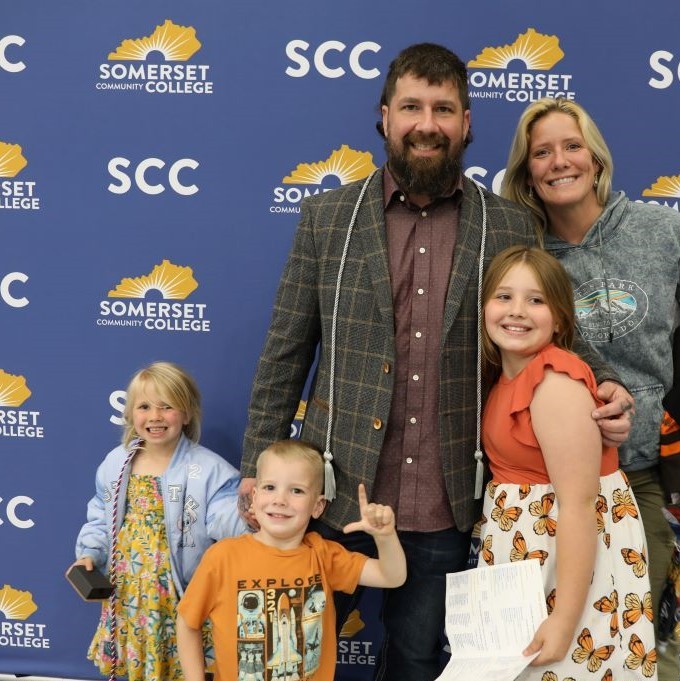 SCC student and veteran celebrates with his family after receiving recognition for his service as a veteran and academic achievements at SCC.