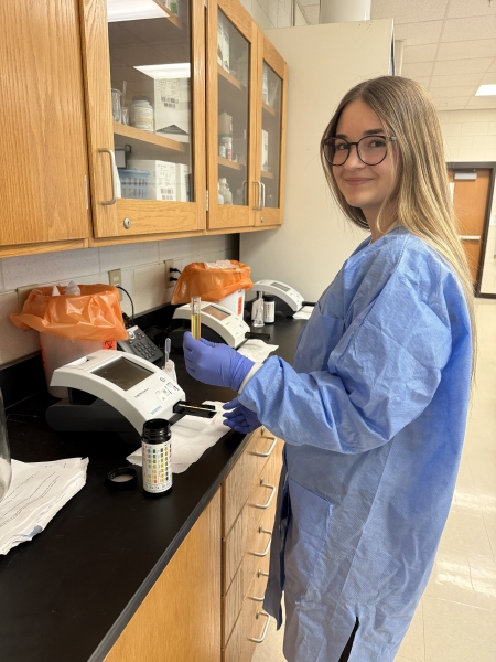 Erica Cole working with lab equipment at SCC