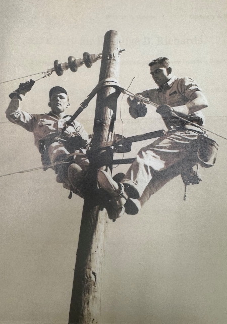 Eldridge Richards (on the right) with another person on the left on top of a line pole in the early years of being a lineman