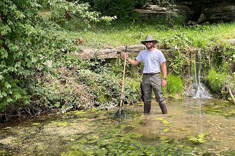 Harrison Dalton cleans out the officer spring at Camp Nelson National Monument near Nicholasville, Ky. An intern with the Student Conservation Association, Dalton says he works “side-by-side with National Park Service staff.