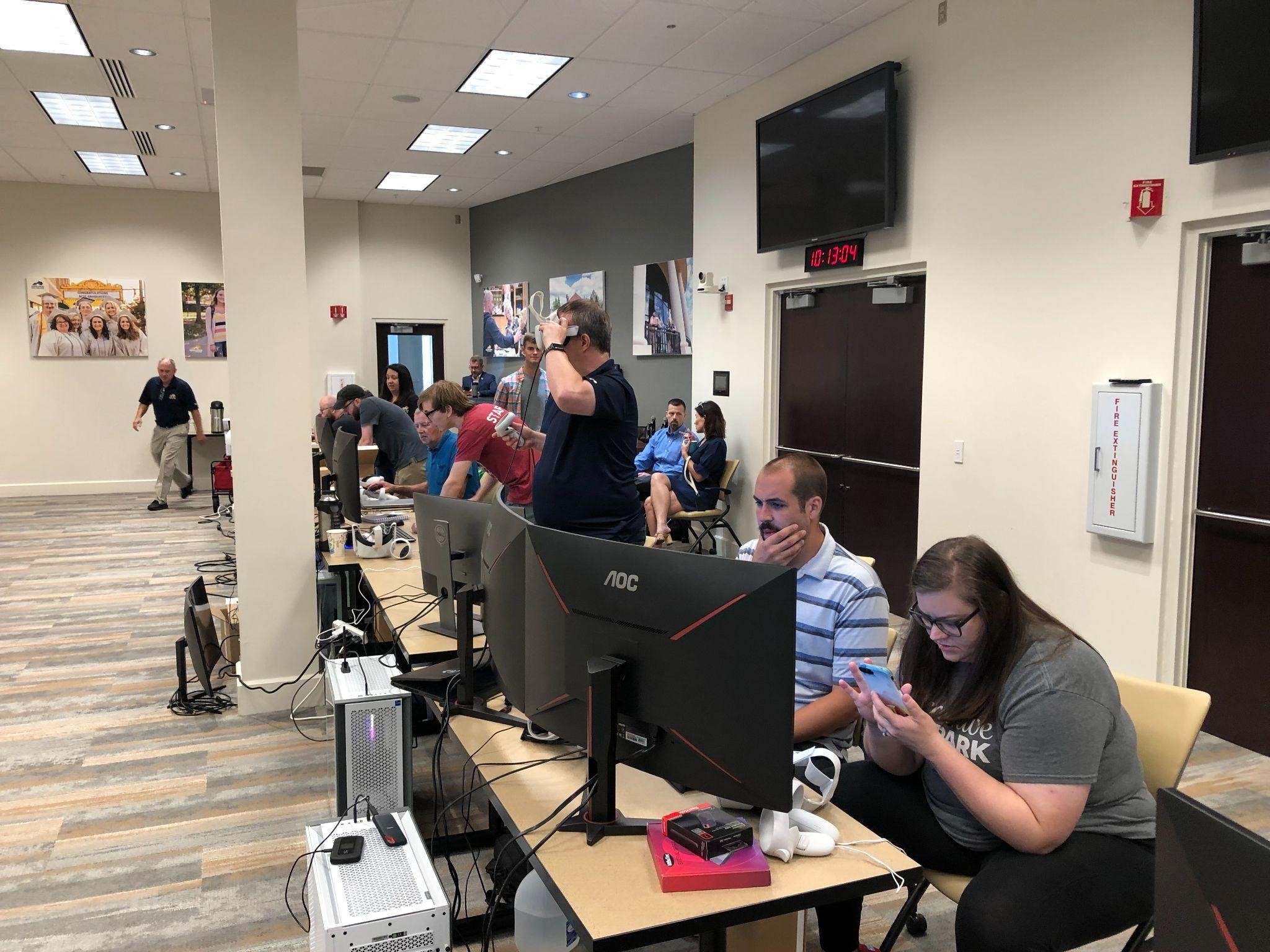 participants working on their VR content with computers and VR headsets