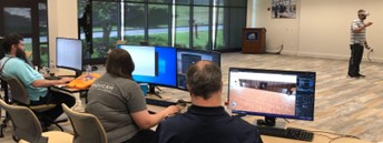 College faculty are instructed on how to create 3D models for their VR modules from Low-cost VR project staff. Another angle of participants working on computers.